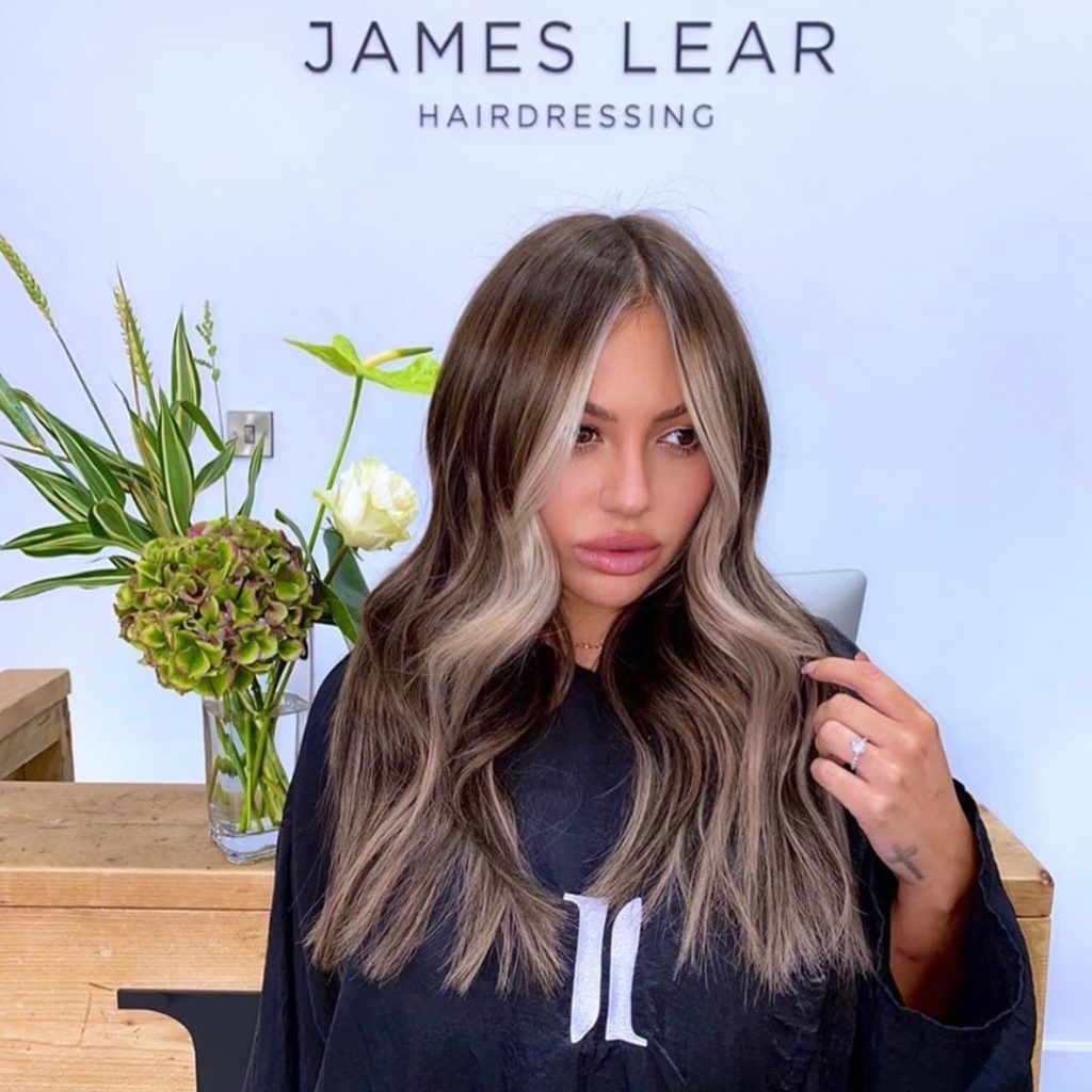 Holly Hagan wears 18” Invisi®️Tape extensions in shades ‘Cool Brown’ & ‘Raven’.